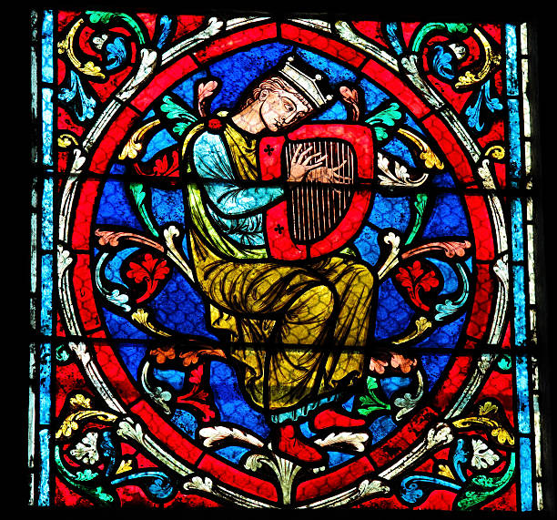 Harpist - Medieval Music Stained glass window in the Notre Dame Cathedral in Paris, created in the 13th Century, depicting a harpist (harp player). psaltery stock pictures, royalty-free photos & images