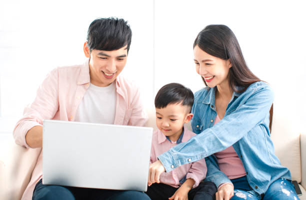 istock happy family watching the laptop  on sofa 1206987274