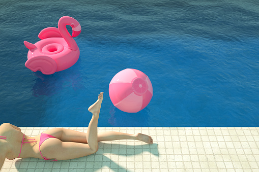 3d rendering of swimming pool. Summer Concept. Travel destinations. Sexy girl in a pink color bikini sunbathing in the pool. Inflatable Flamingo and Beach Ball.