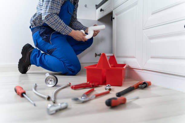 istock Male Plumber In Overall Fixing Sink Pipe 1206990024