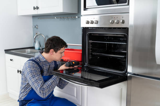 istock Repairman Repairing Oven 1206990041