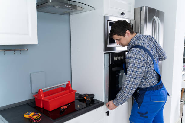 istock Repairman Repairing Oven 1206990052