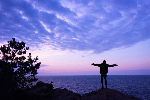 istock Young man rise hand and Refresh at the mountain 1206990120