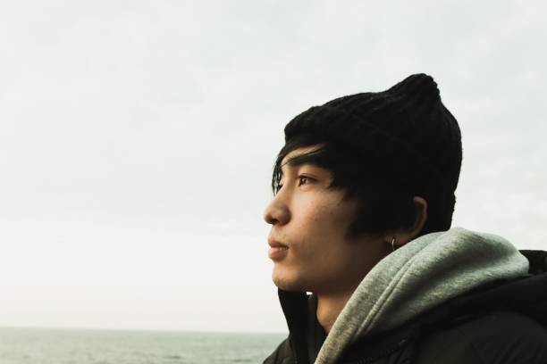 istock Young man looking over at the cliff 1206990221