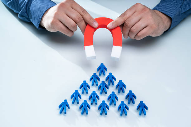 istock Businessman Attracting Blue Team With Horseshoe Magnet 1206990354