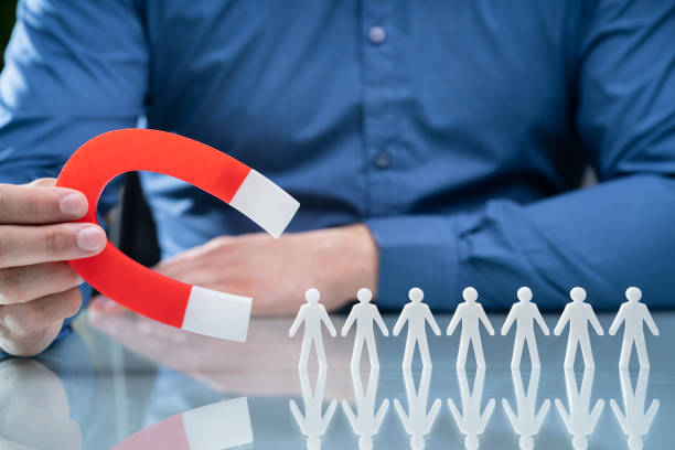 istock Businessperson Attracting Human Figures With Horseshoe Magnet 1206990355
