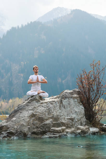 istock A young man practices yoga. Exercise Agni Stambhasana. 1206993026