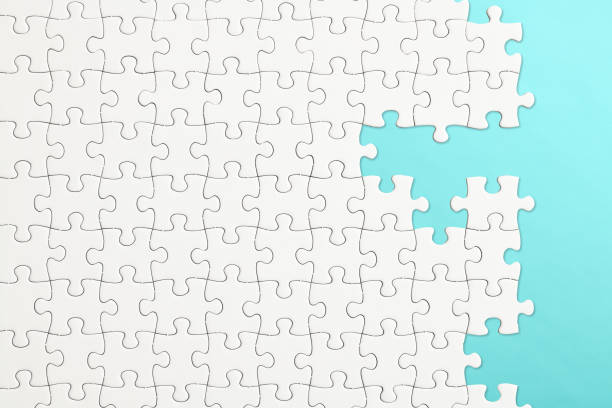 white blank jigsaw puzzle on light blue background - teamwork absence blank jigsaw puzzle imagens e fotografias de stock