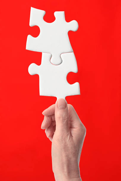 istock Holding a blank Jigsaw puzzle against red background 1206993080
