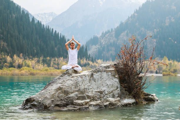 istock A young man practices yoga. Exercise Agni Stambhasana. 1206993592