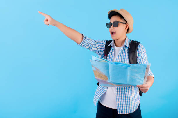istock Young Asian man used the map and smiled happily separately on the blue background. 1206993901
