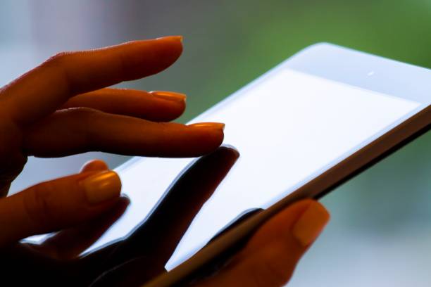 istock Female finger clicks on a digital tablet, business and technology concept. Close up 1206995933
