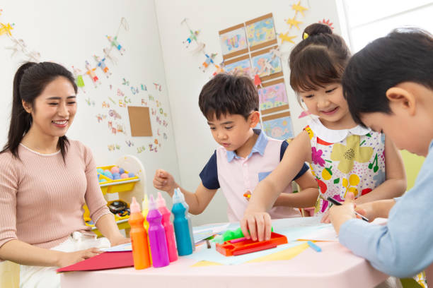 istock Kindergarten teachers and the children 1206995986