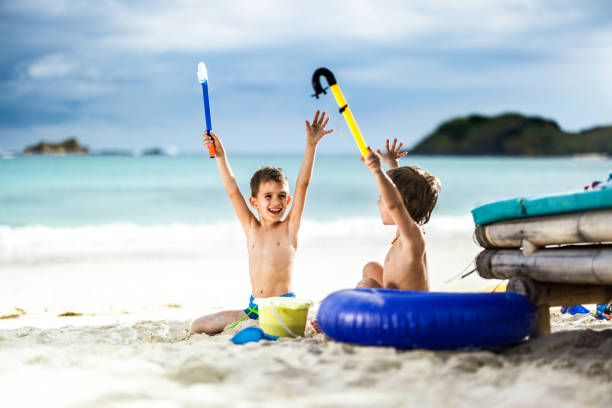 istock Happy little boys having fun in sand on the beach. 1206997323