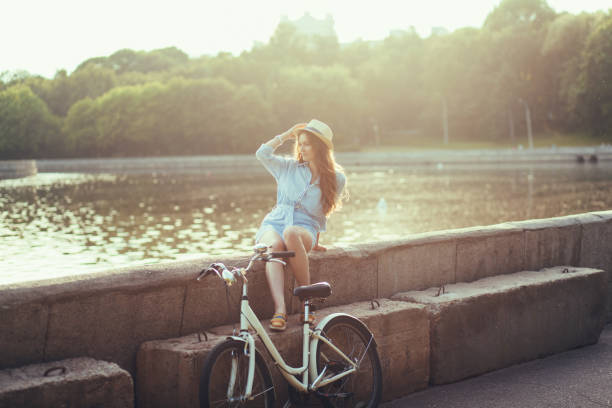 istock woman in a park with a bicycle 1207000843