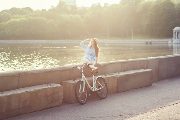 istock woman riding vintage bicycle on park 1207000851