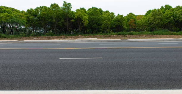 istock New asphalt roads, trees under blue sky and white clouds 1207000930