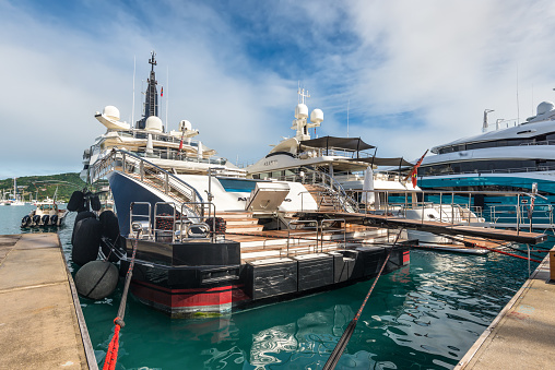 English Harbour, Antigua and Barbuda - December 18, 2018: Luxury motor yachts docked at the Antigua yacht club in English Harbour, St. Paulâs Parish, Antigua And Barbuda.
