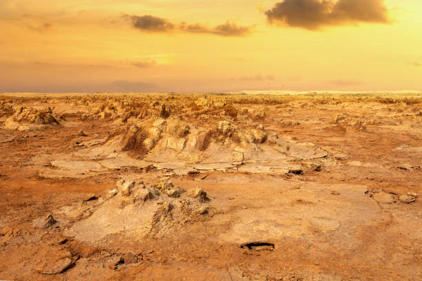 abstract landscape in Dallol, Danakil depression, Ethiopia abstract apocalyptic incredible landscape of Dallol desert situated in the Afar Triangle, land like moonscape. Hottest place on Earth with non realistic sky. dallol ethiopia stock pictures, royalty-free photos & images