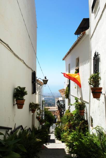 Old town street, Mijas, Spain. View along an old town side street towards the countryside, Mijas, Malaga Province, Spain mijas pueblo stock pictures, royalty-free photos & images