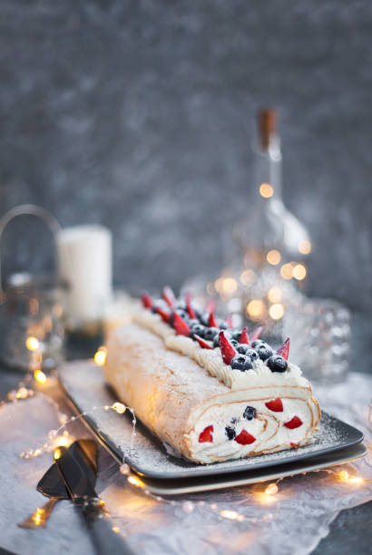 istock Meringue roll cake with cream and fresh berries 1207005560
