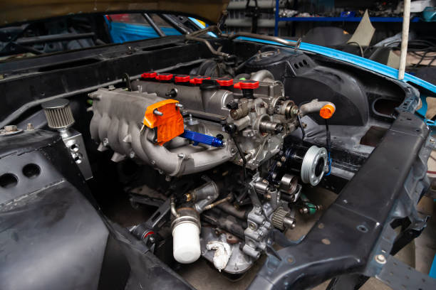 istock Powerful tuned gasoline engine with a turbocharger and a charger in the engine compartment of the car with an open hood in a car repair and improvement workshop. 1207007025