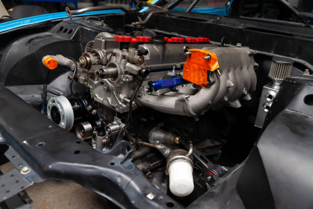 istock Powerful tuned gasoline engine with a turbocharger and a charger in the engine compartment of the car with an open hood in a car repair and improvement workshop. 1207007299