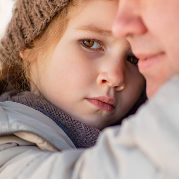 istock Daddy's daughter in winter clothes 1207008472