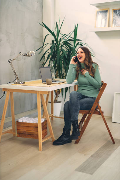 istock Young attractive female having phone call in modern office. 1207009793