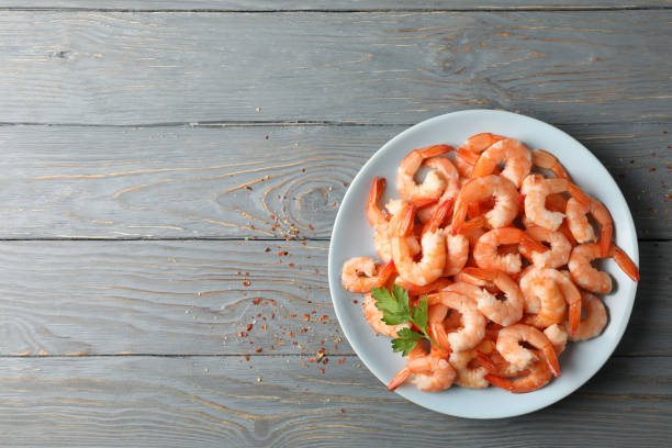 istock Plate with shrimps on wooden background, top view 1207011684