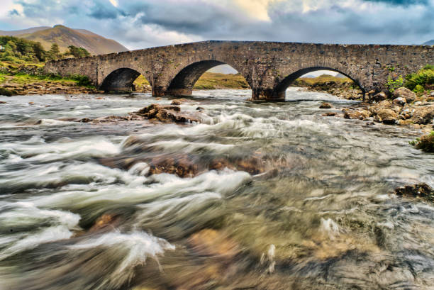 Looking at the Sligachan Old Bridge on The Isle of Skye, Scotland. It is close to the Cuillin mountains and provides a good viewpoint for seeing the Black Cuillin mountains.