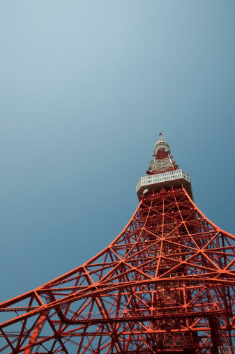 A low angle view of Tokyo Tower against blue sky.
