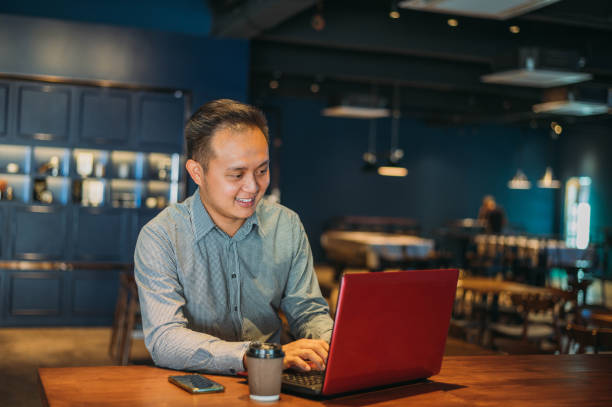 istock Asian businessman working at cafe 1207021416