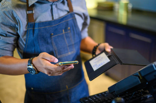 istock Asian Barista working and checking email on smartphone. 1207021884