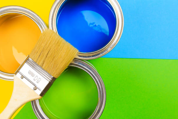 istock Metal paint cans and paint brushes on multicolor background. Top view. Copy space. 1207024363
