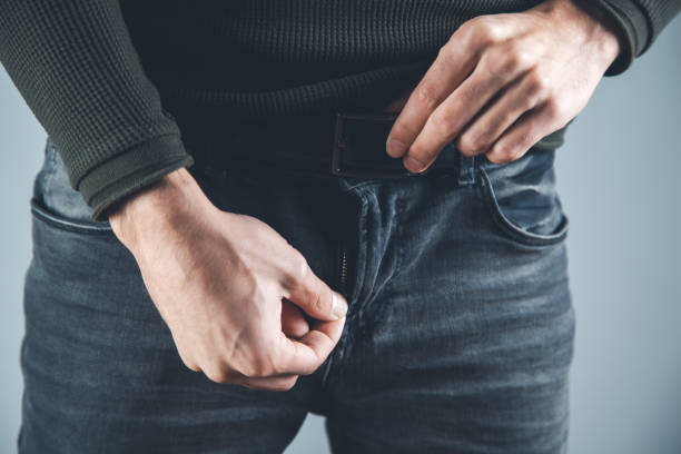 istock man  hand chain in pants on gray background 1207025095
