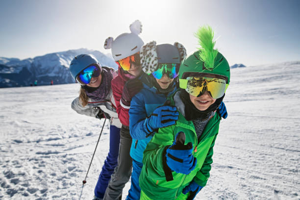 family enjoying skiing together at glacier in the alps - beauty teenage girls women in a row imagens e fotografias de stock