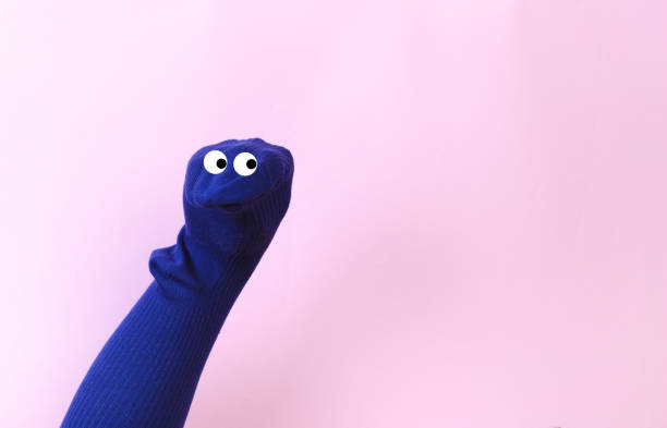 funny doll sock on pink background, hand theater