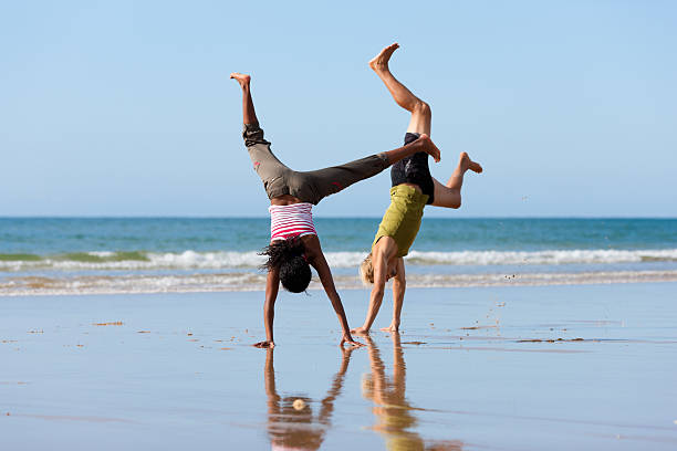 istock Sport couple doing gymnastics on the beach 120702661