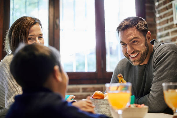 istock Parents having breakfast with son at home 1207027466