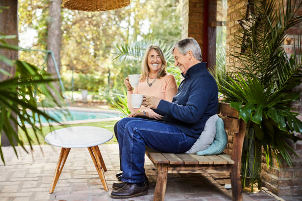 istock Elderly couple enjoying coffee at patio 1207027468