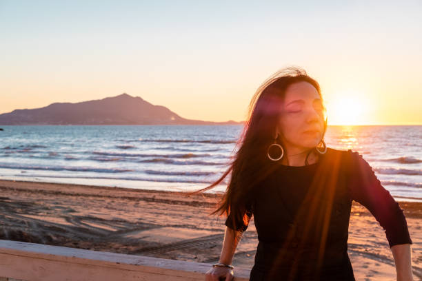 istock Woman on Italian Beach at sunset 1207032170