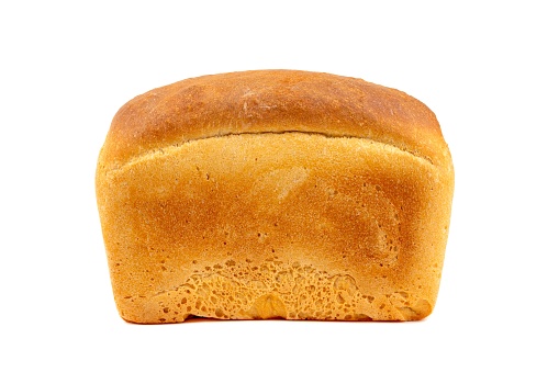 A whole loaf of white bread isolated on a white background close up side view