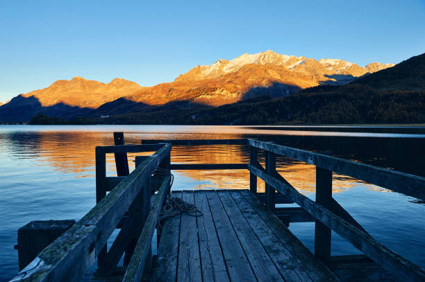 istock Small pier on the alpine lake 1207036612