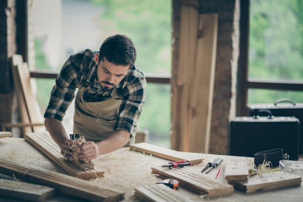 istock Portrait of his he nice attractive skilled hardworking guy creative self-employed engineer carving wood home-based studio manufacture at modern industrial loft brick style interior indoors 1207037612