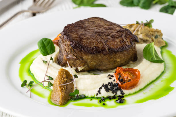istock Delicious beef steak on wooden table, close-up 1207037717