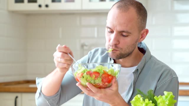 Man eating fresh tasty salad healthy eating