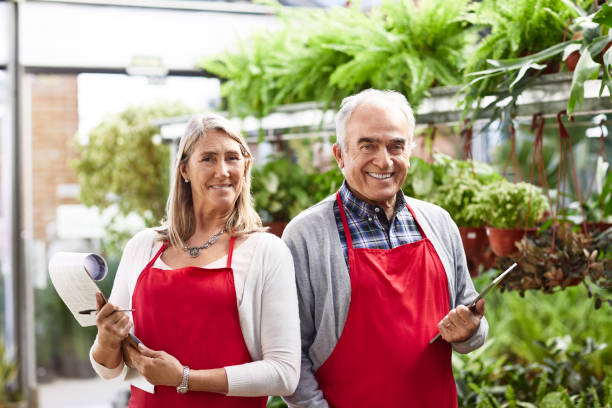 istock Confident senior florists at greenhouse 1207038431