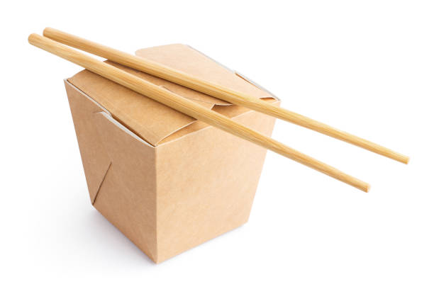 istock Closed wok paper box with chopsticks on white 1207038998