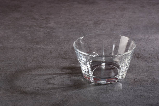 istock Empty glass bowl on the gray stone texture 1207040471